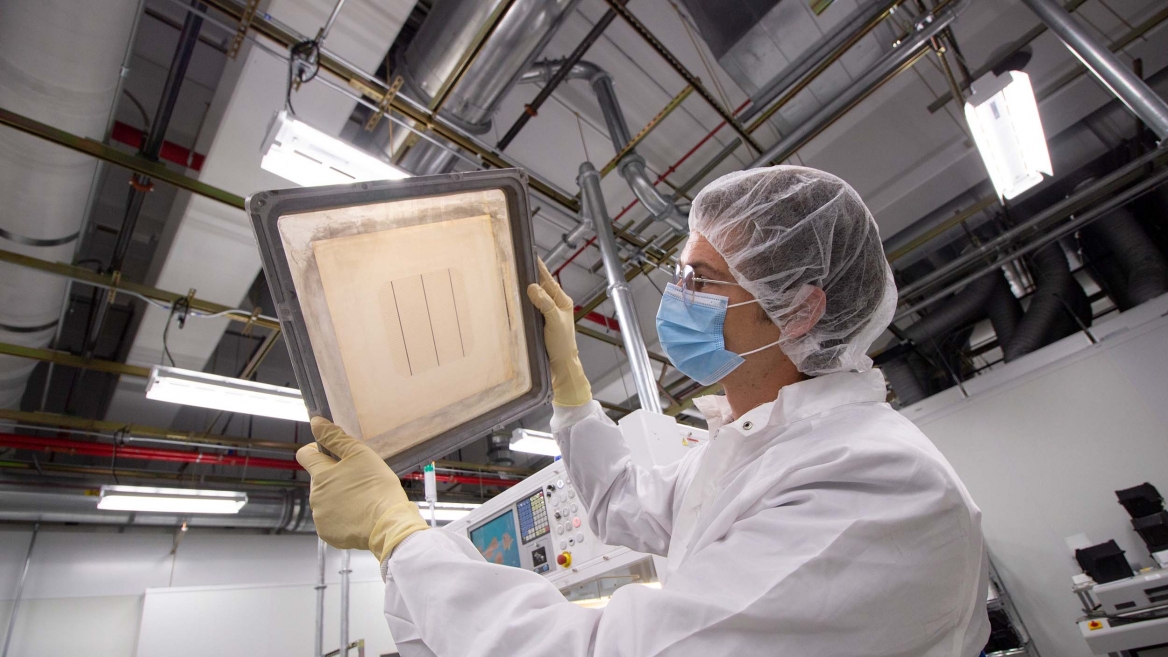 A researcher examines semiconductor material at an ASU MacroTechnology Works lab.